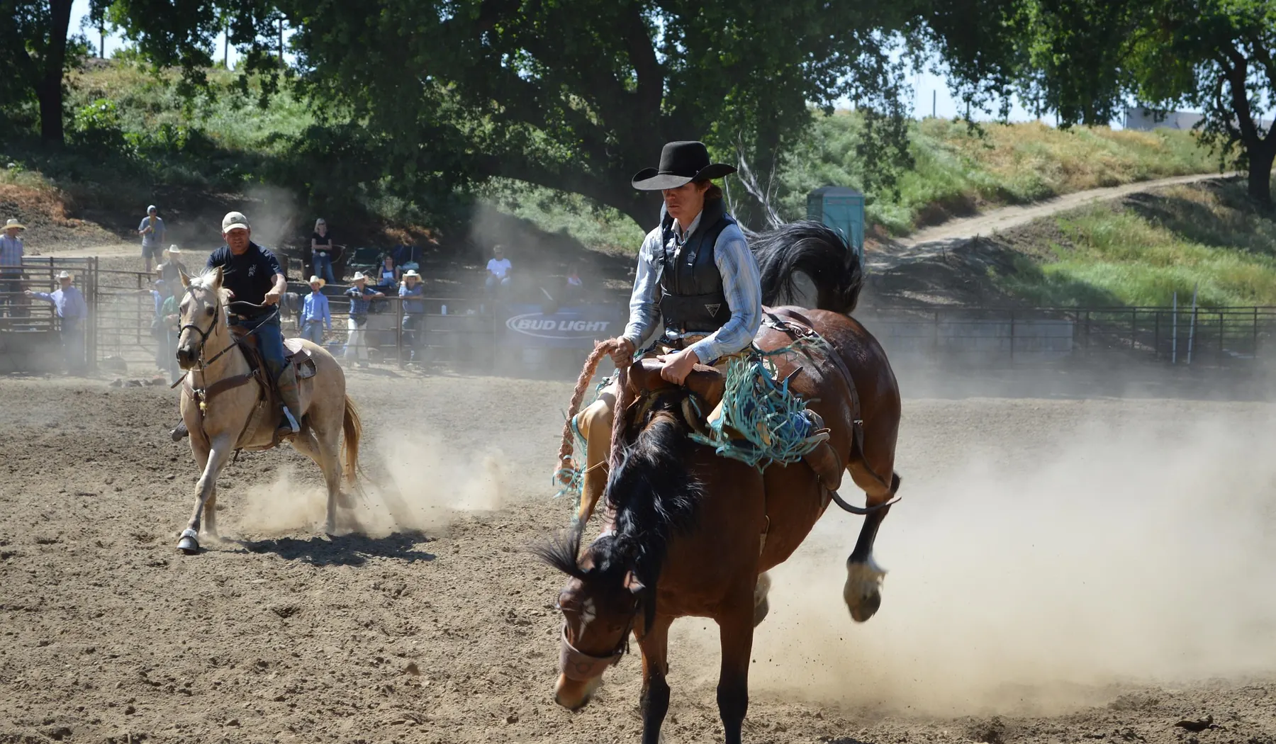 Competitors and spectators across a country rodeo arena