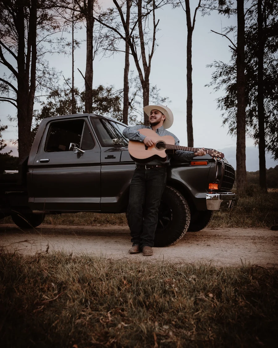 Tate Cole with an acoustic guitar